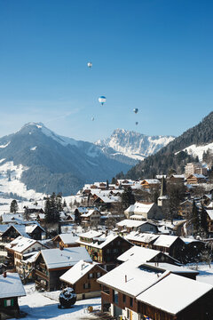 Hot Air Balloons Floating above snowy alpine village
