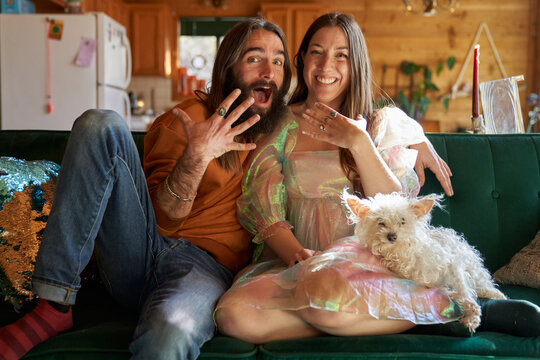 Happy couple engaged on couch