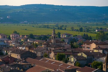 Houses of the old historical city of Soave in Italy with mountains in the background