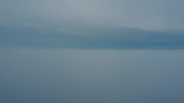 Aerial of the big white low clouds and fog covering the mountain peaks in Verona Italy