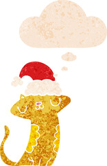 cute cartoon cat wearing christmas hat and thought bubble in retro textured style