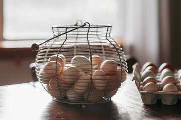 Fresh eggs in a metal basket