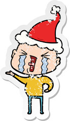 distressed sticker cartoon of a crying bald man wearing santa hat