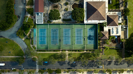 Tennis courts in an urban park area from above.
