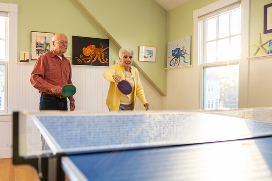  Senior Citizen partner  lifestyle couple playing ping pong 