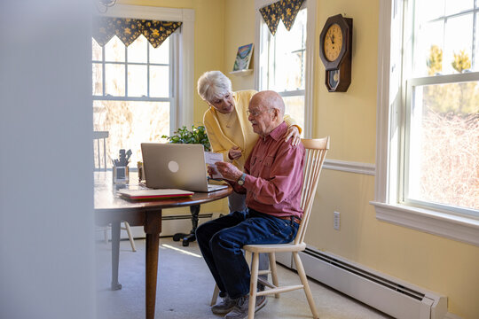 Family finance day for senior couple at home 