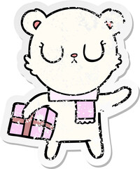 distressed sticker of a peaceful cartoon polar bear with christmas gift
