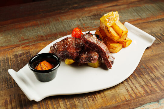 Grilled meat with sauce and potatoes