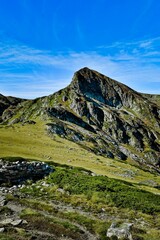 Landscape view in Seven Rila lakes with green fields and mountains, clear sky background