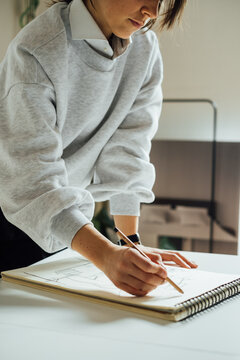Cropped Image of Woman Drawing in Her Sketchbook