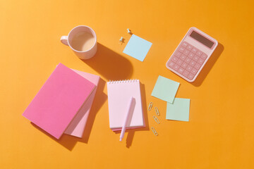 Top view over the working desk with notebook, pencil and calculator