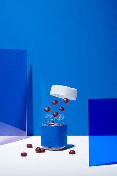 Multivitamin Gummies  from glass bottle on blue background