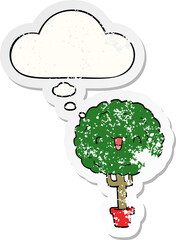 cartoon happy tree and thought bubble as a distressed worn sticker