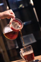 Professional barista preparing coffee. Young woman making coffee. Alternative ways of brewing coffee. Coffee shop concept
