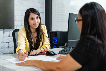 Woman architect attending to her client.