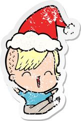 distressed sticker cartoon of a happy hipster girl wearing santa hat