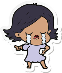 sticker of a cartoon girl crying and pointing