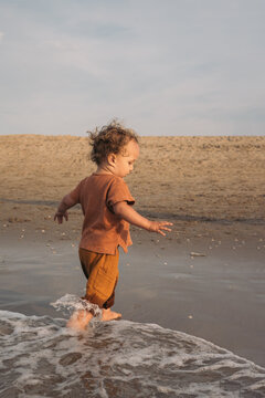 Toddler running on the beach