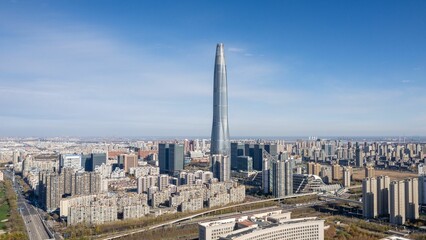 Aerial shot of a high tower building in Tinajin and other modern buildings