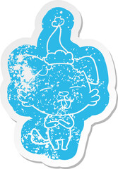 cartoon distressed sticker of a dog sticking out tongue wearing santa hat