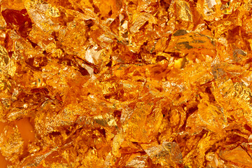 Golden texture background. Golden potal close-up glitters and shimmers. Golden holiday background.