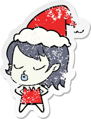 cute distressed sticker cartoon of a vampire girl wearing santa hat