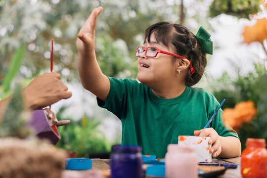 Little girl with down syndrome smiling.