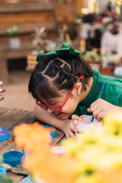 Little girl artist in the garden.