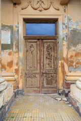 Ancient wooden carved door with stucco