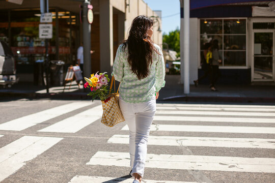 Woman by pedestrian crossing in the city