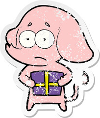 distressed sticker of a cartoon unsure elephant with christmas present