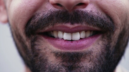Obraz premium Macro closeup of a Middle Eastern man smile. Mouth and teeth close up detail of an Arab male person smiling. Bearded guy with Happy Expression