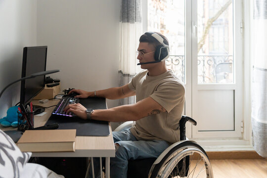 Young Adult Wheelchair User Using A Desktop Computer