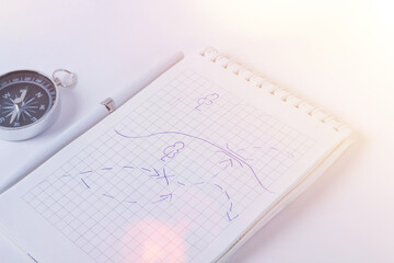 Traveler's notes. A clean notebook with a pen for writing a compass and a map . The concept of travel.