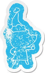 happy cartoon distressed sticker of a bear giving thumbs up wearing santa hat