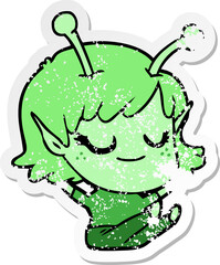 distressed sticker of a smiling alien girl cartoon sitting