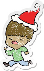 distressed sticker cartoon of a stressed man wearing santa hat