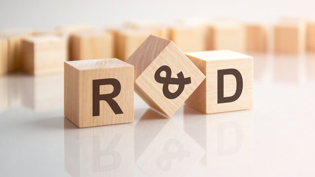 word R and D made with wood building blocks, stock image. background may have blur effect