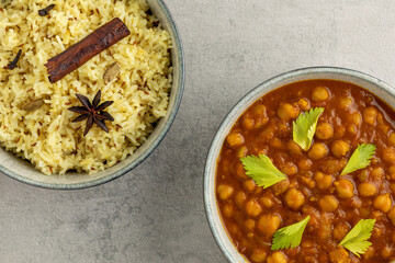 Chana masala and jeera rice in bowls. Indian cuisine meal.