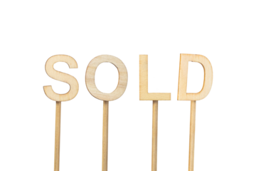 ¨Sold¨ sign made with individual wooden letters on a green chroma background.