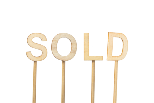 ¨Sold¨ sign made with individual wooden letters on a green chroma background.