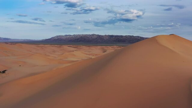 Aerial view of the big sand dune Hongoryn Els in Gobi Desert at sunset, Mongolia, 4k