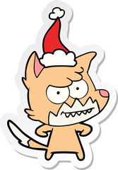 sticker cartoon of a grinning fox wearing santa hat