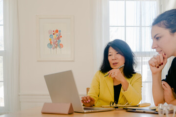 two women working  together on project 