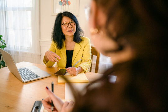 woman listening to young woman during interview