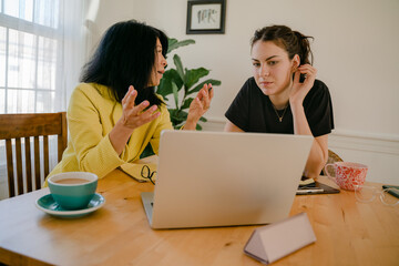 woman explaining a business project to her younger co worker 