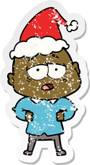 distressed sticker cartoon of a tired bald man wearing santa hat