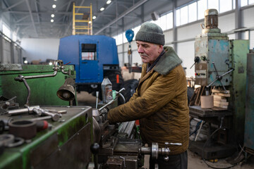 senior worker of factory machine