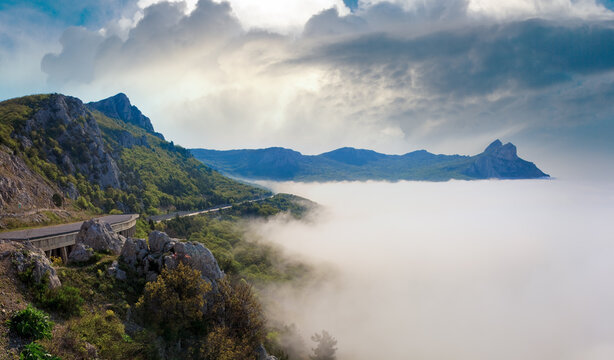 Morning view of coastline in mist (like cloudy sea) and highway (Foros Town environs, Crimea, Ukraine).