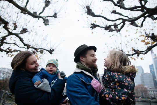 Spouses and kids under the trees in the city